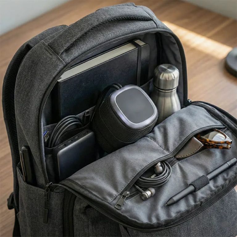 Portable Bluetooth speaker with a light-up logo and lanyard