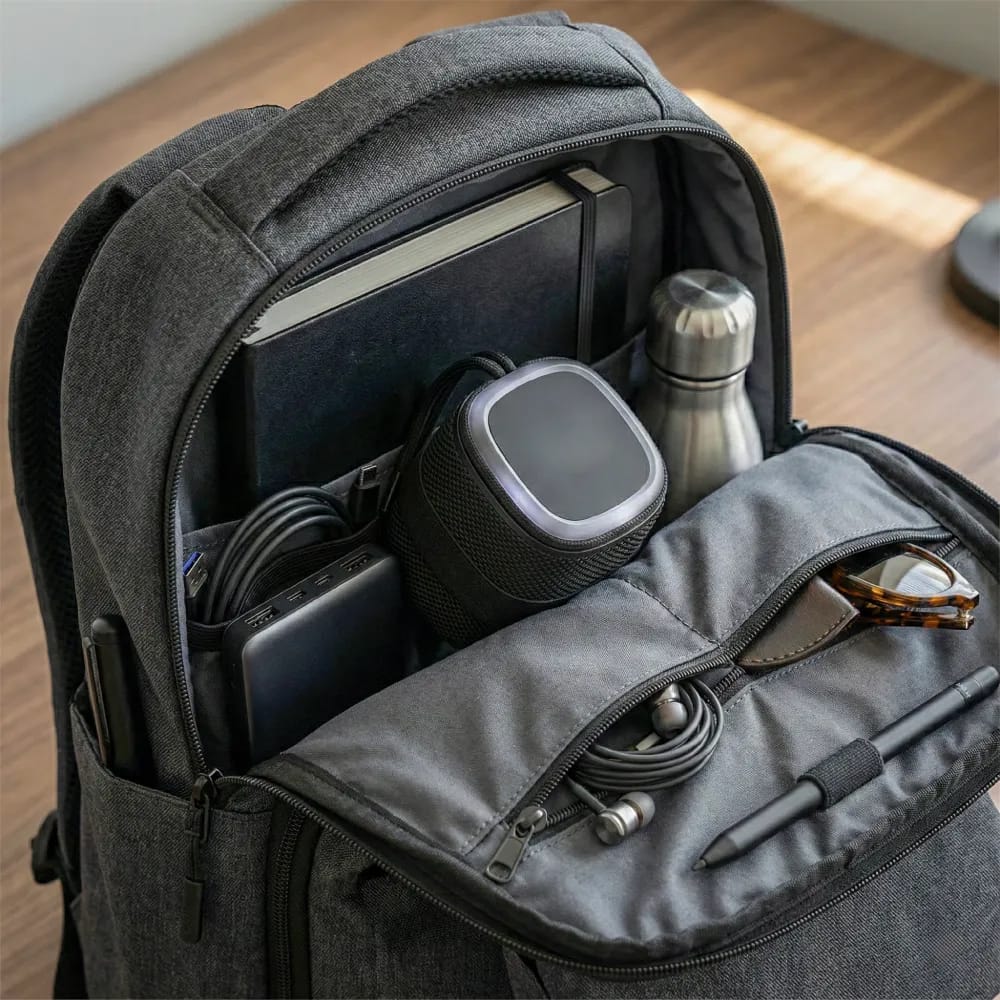 Portable Bluetooth speaker with a light-up logo and lanyard